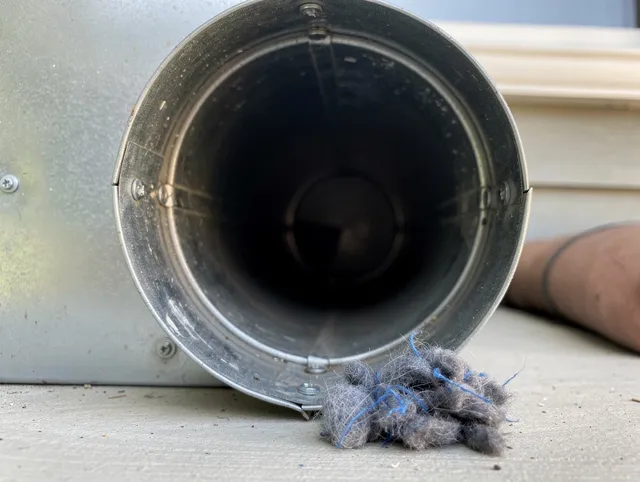 Wildomar Dryer Vent Cleaning technician using specialized equipment to clear severe dryer vent blockage in Wildomar
